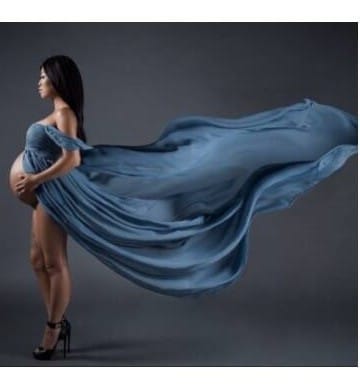 Maternity photoshoot glow in a flowing gown